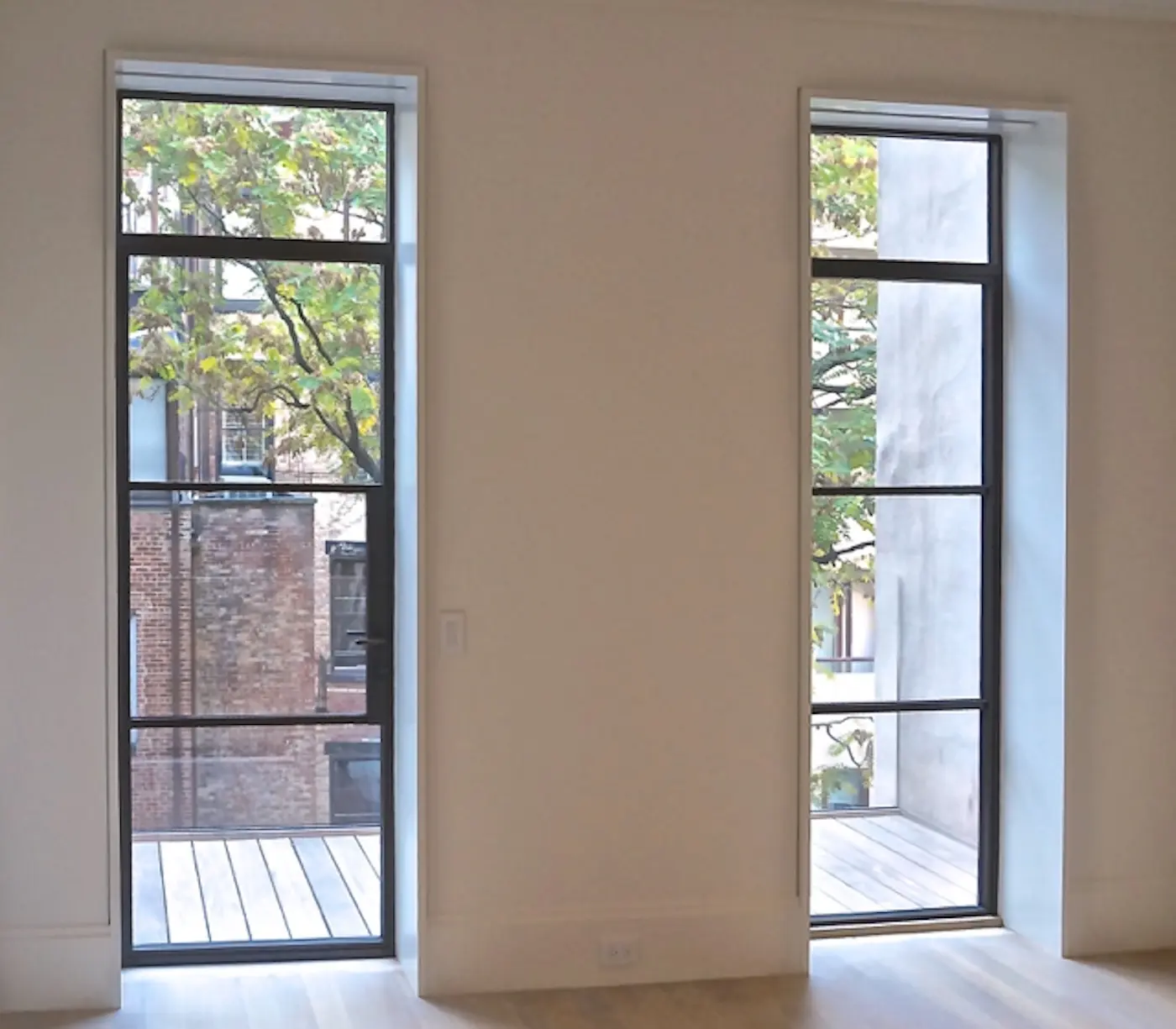 Thermal bronze swing door pairs with transoms, SDL muntins, high performance insulating glass