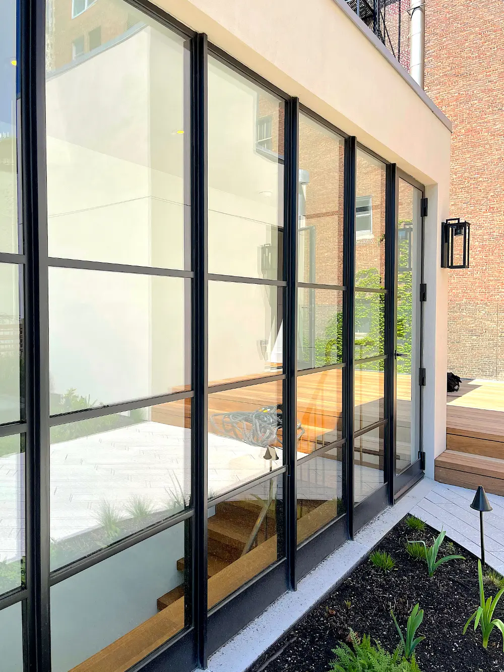 Thermal Steel window wall with swing door, powder coat finish, SDL muntins, vertical mullions, high performance insulating glass